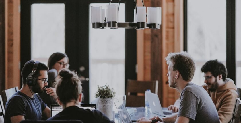 Freelancing vs full-time jobs abroad — international worker on laptop in coworking space 2026